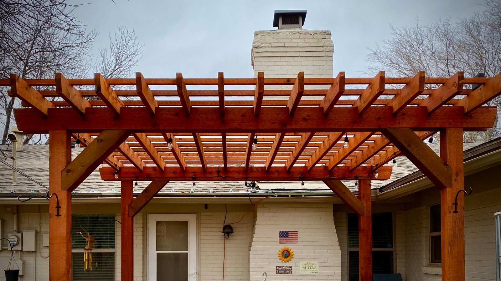 Custom cedar pergola with lattice roof over a paver patio — Creative TimberWorks, Abilene TX